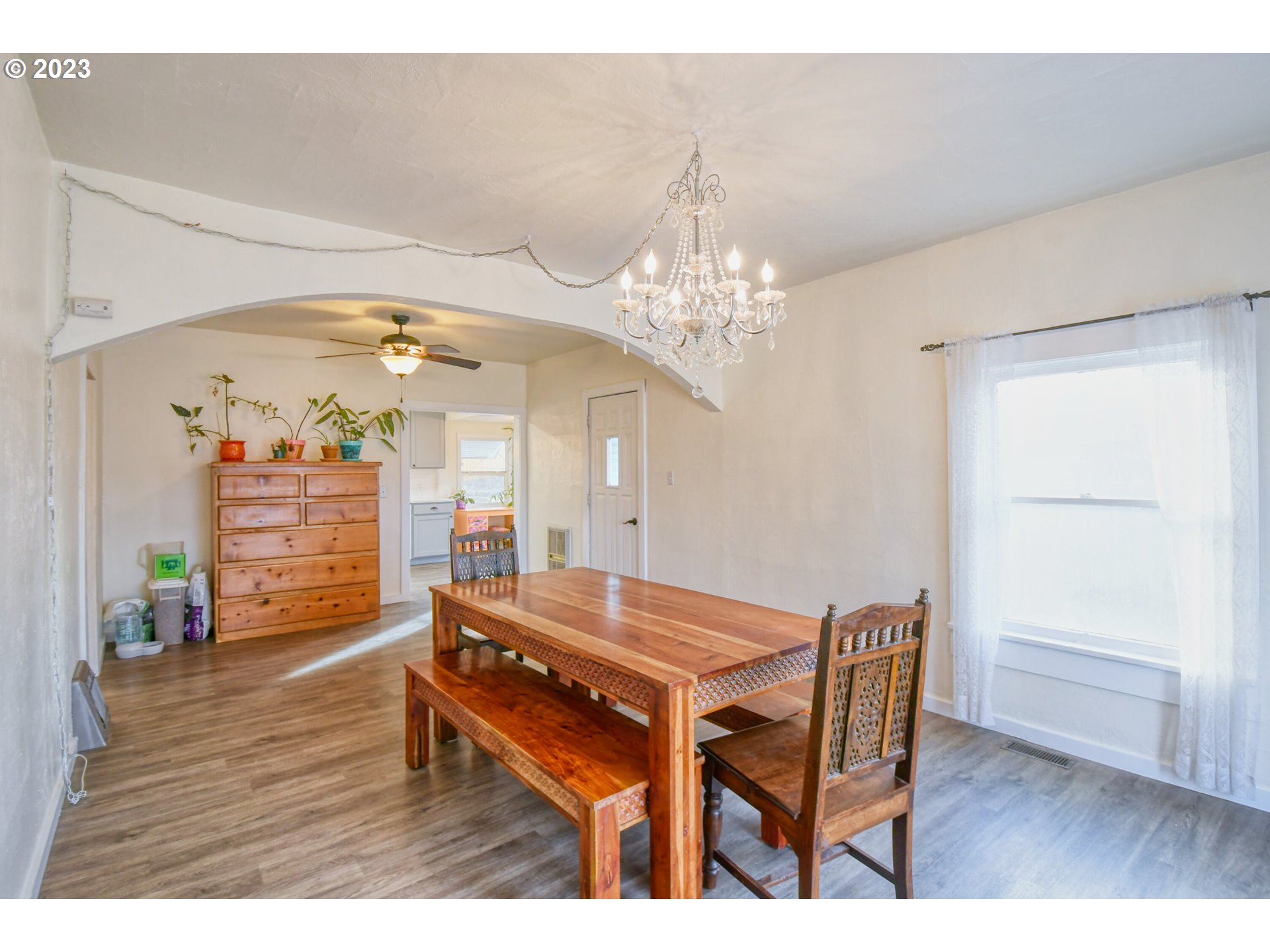 2002 Southeast Court Avenue Pendleton, OR 97801 - Photo 8 of 32 a dining room with wooden floor a chandelier a wooden table and chairs