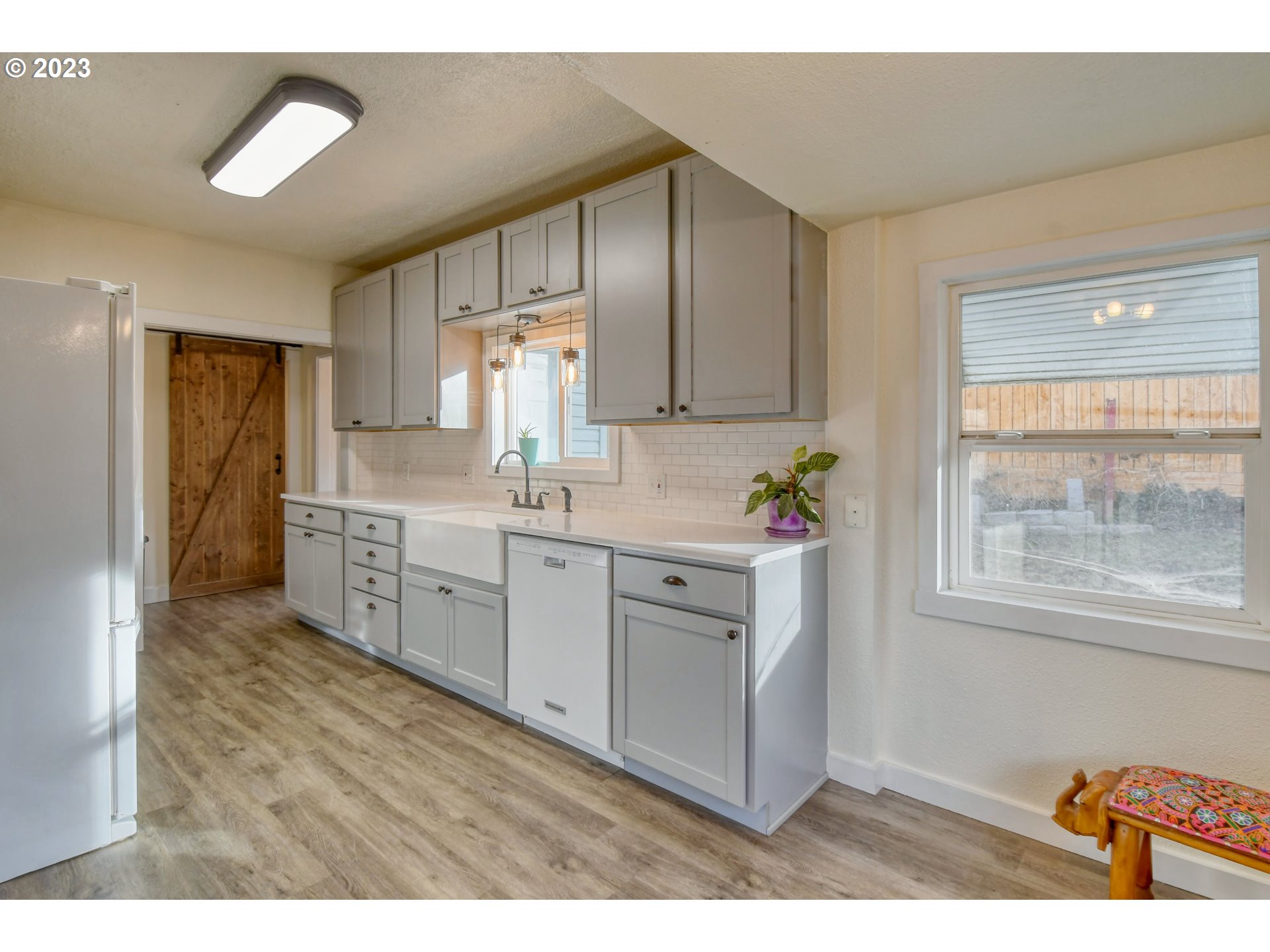 2002 Southeast Court Avenue Pendleton, OR 97801 - Photo 9 of 32 a kitchen with white cabinets a sink a window and stainless steel appliances