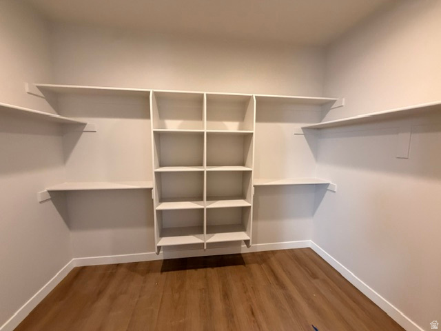 5885 Canyon Rim Road, Unit 624 Lehi, UT 84048 - Photo 8 of 10 Walk-in closet featuring built-in shelving, cubby storage, and wood-finish flooring