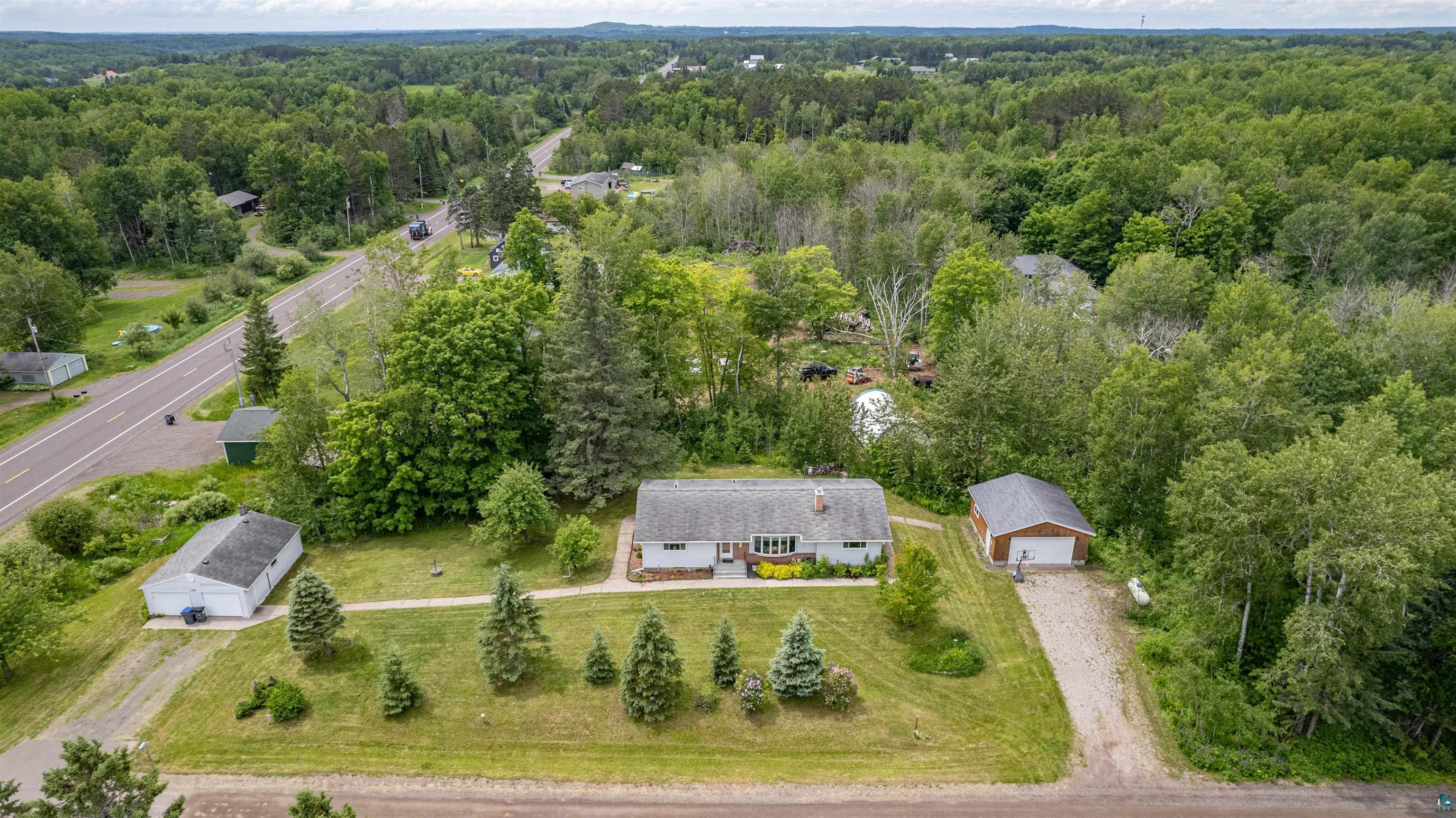 3711 Getchell Road Hermantown, MN 55811 - Photo 26 of 31 Expansive property featuring a single-story residence, two detached garages, mature trees, and a gravel driveway
