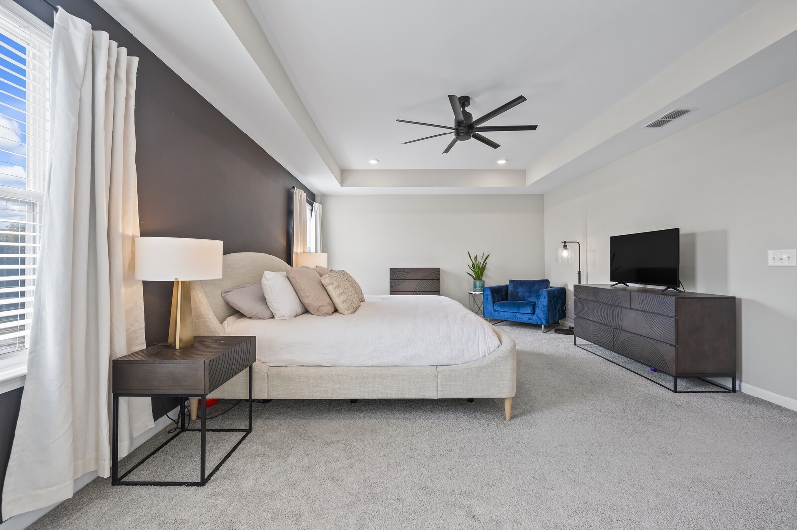 651 Castle Road Mount Juliet, TN 37122 - Photo 19 of 30 a spacious bedroom with a bed a couch and a flat screen tv