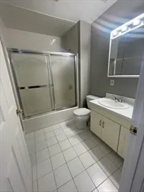 a bathroom with a double vanity sink mirror and toilet