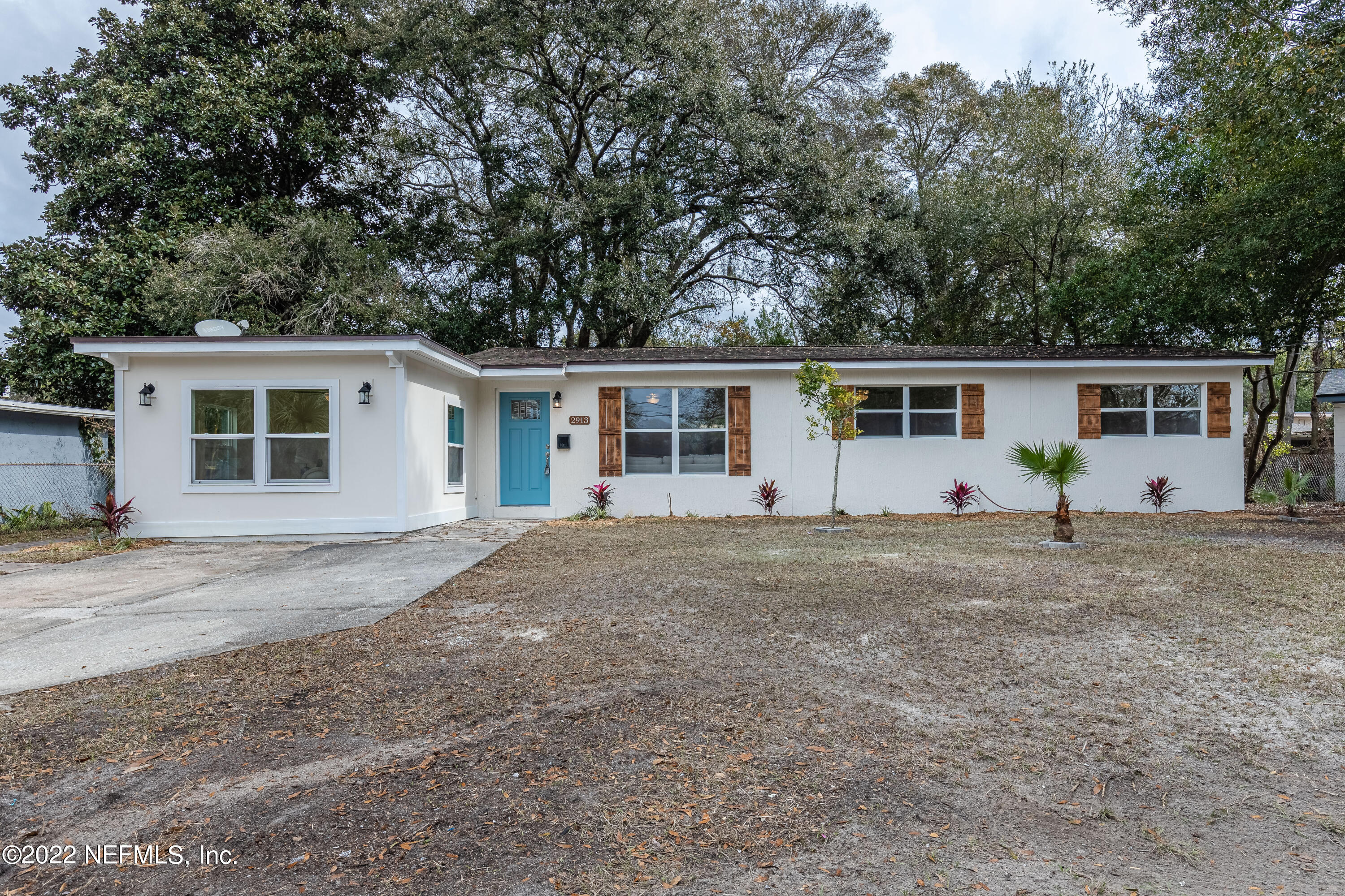 2913 Mansion Road Jacksonville, FL 32277 - Photo 1 of 30 a front view of house with yard and trees around