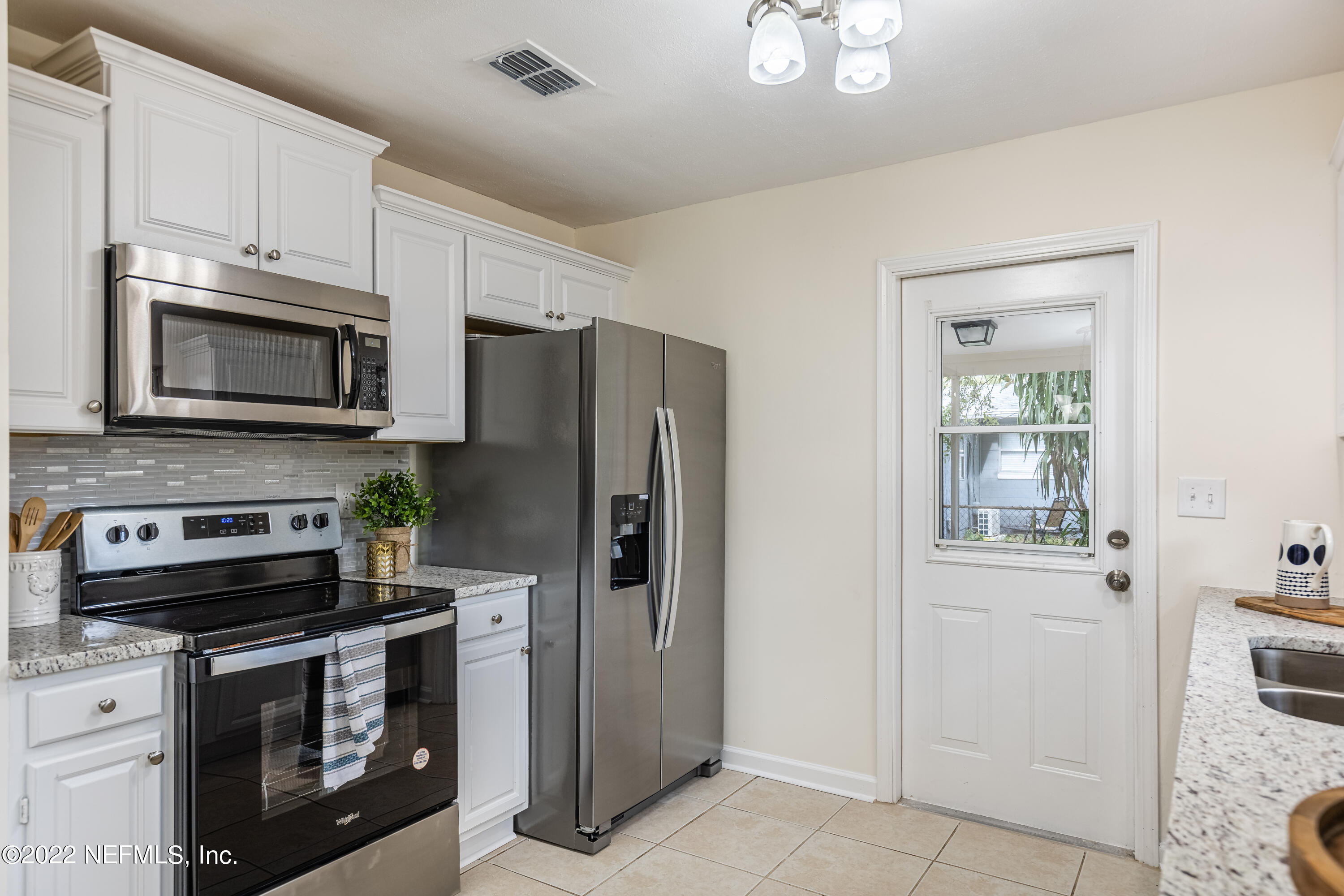 2913 Mansion Road Jacksonville, FL 32277 - Photo 11 of 30 a kitchen with cabinets stainless steel appliances and a counter space