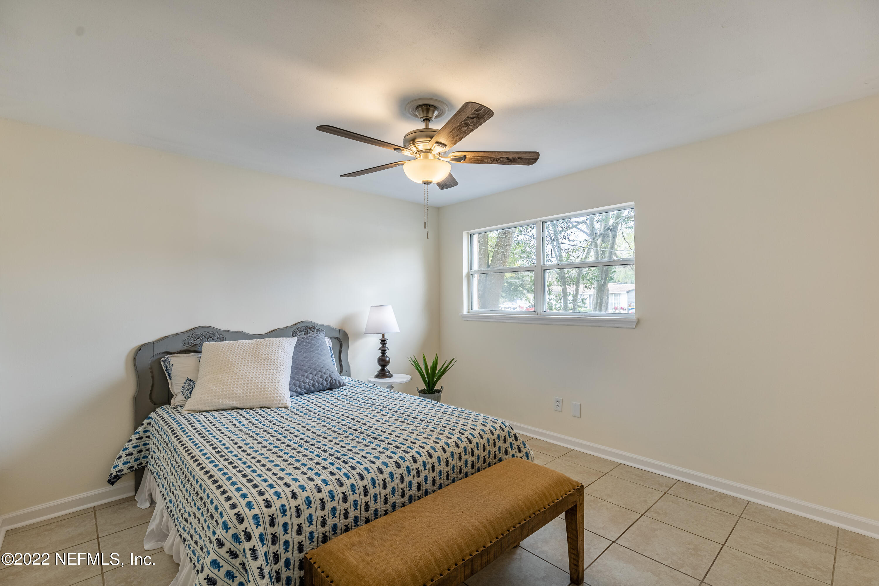 2913 Mansion Road Jacksonville, FL 32277 - Photo 20 of 30 a bedroom with a bed and a ceiling fan