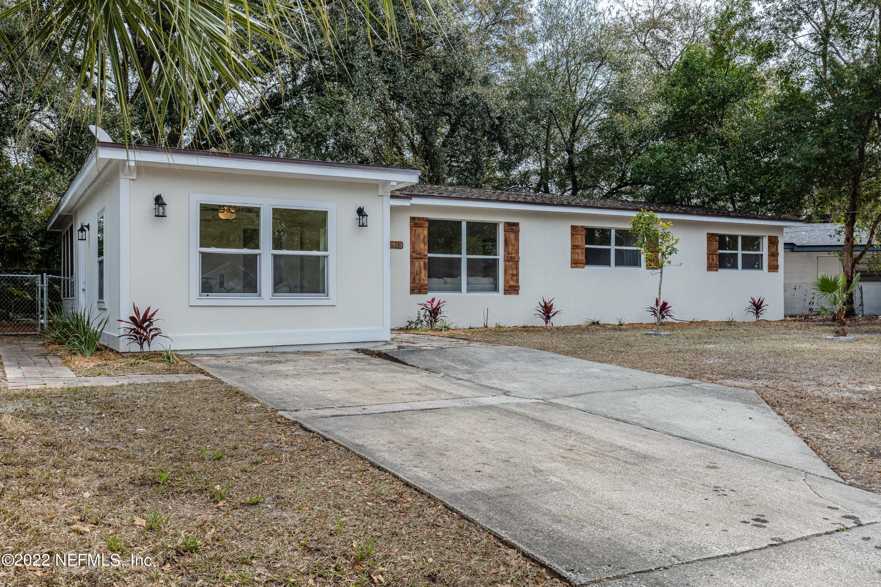 2913 Mansion Road Jacksonville, FL 32277 - Photo 3 of 30 front view of a house with a yard
