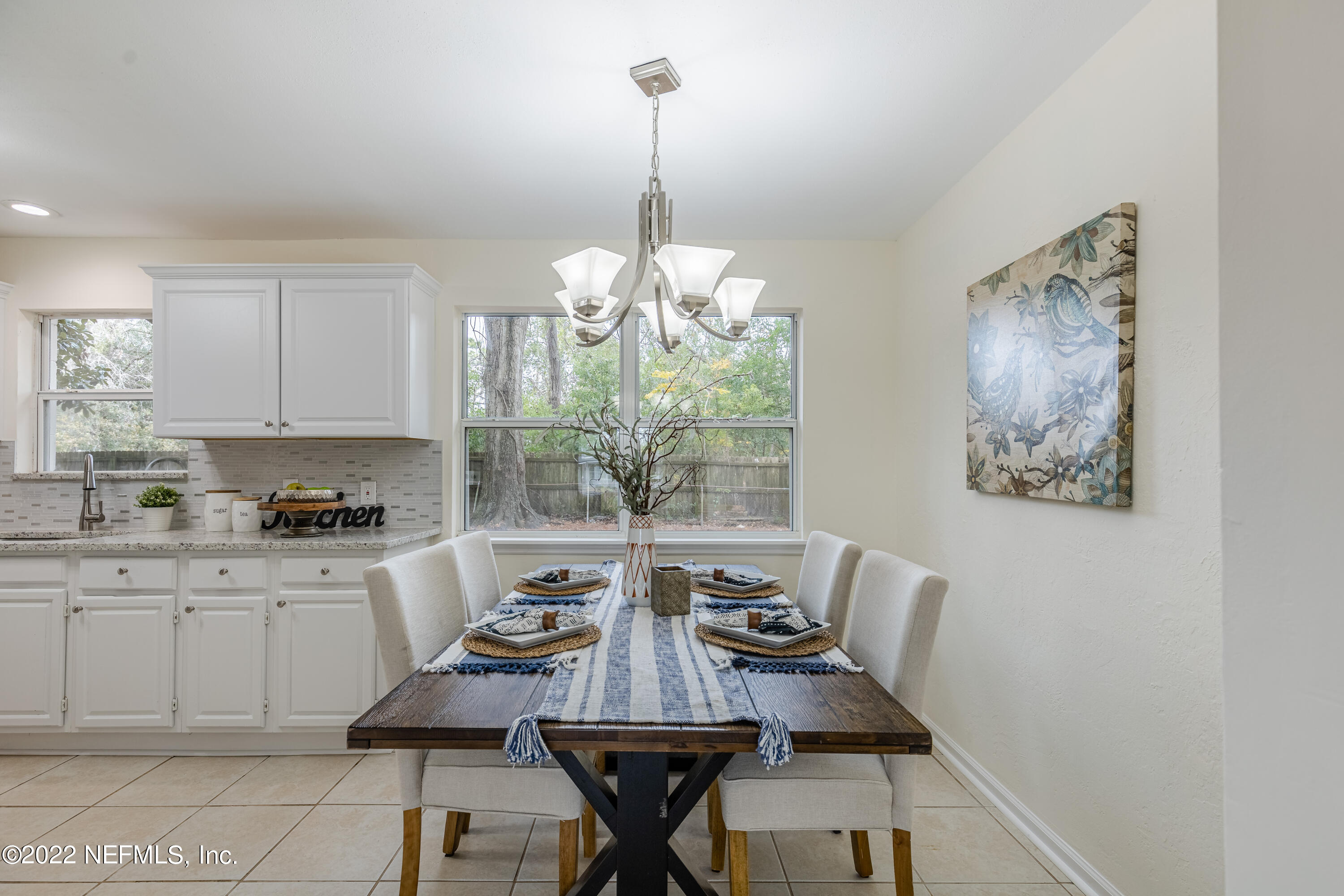 2913 Mansion Road Jacksonville, FL 32277 - Photo 7 of 30 a view of a dining room with furniture and chandelier