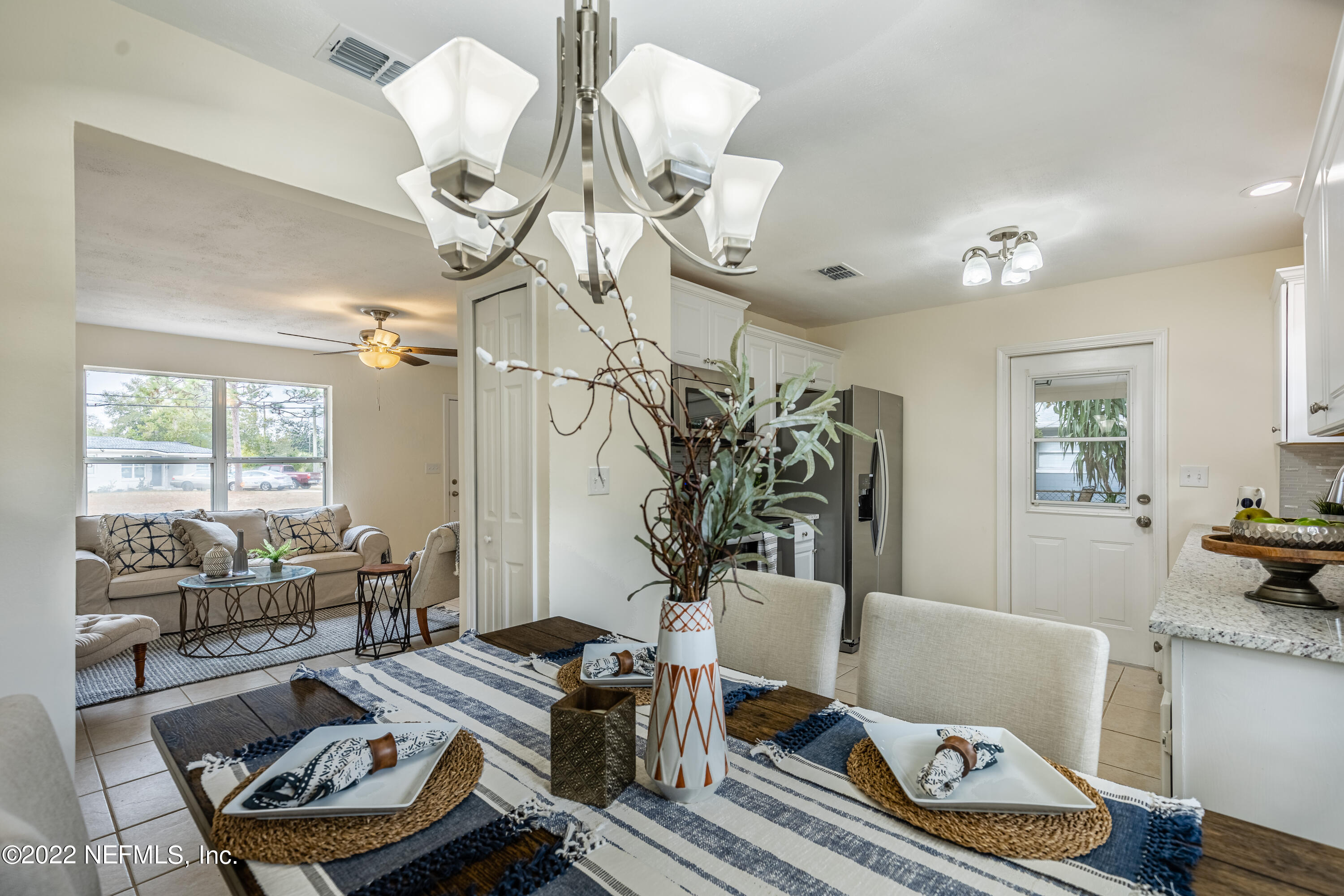 2913 Mansion Road Jacksonville, FL 32277 - Photo 8 of 30 a living room with furniture and a chandelier