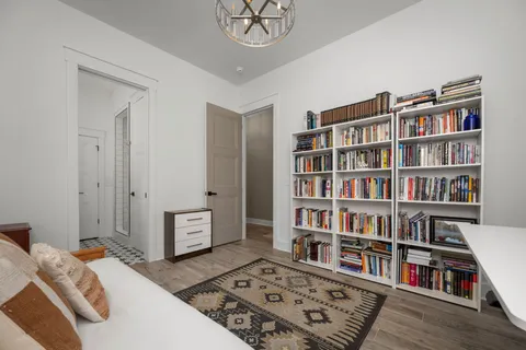 a bedroom with furniture and a book shelf