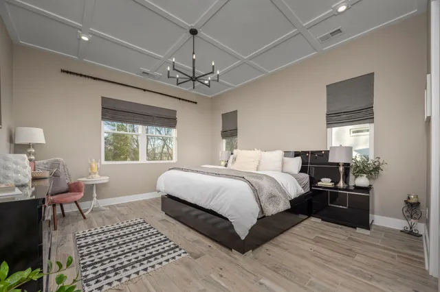 a living room with furniture a flat screen tv and a window