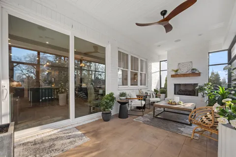 a living room with furniture and a floor to ceiling window
