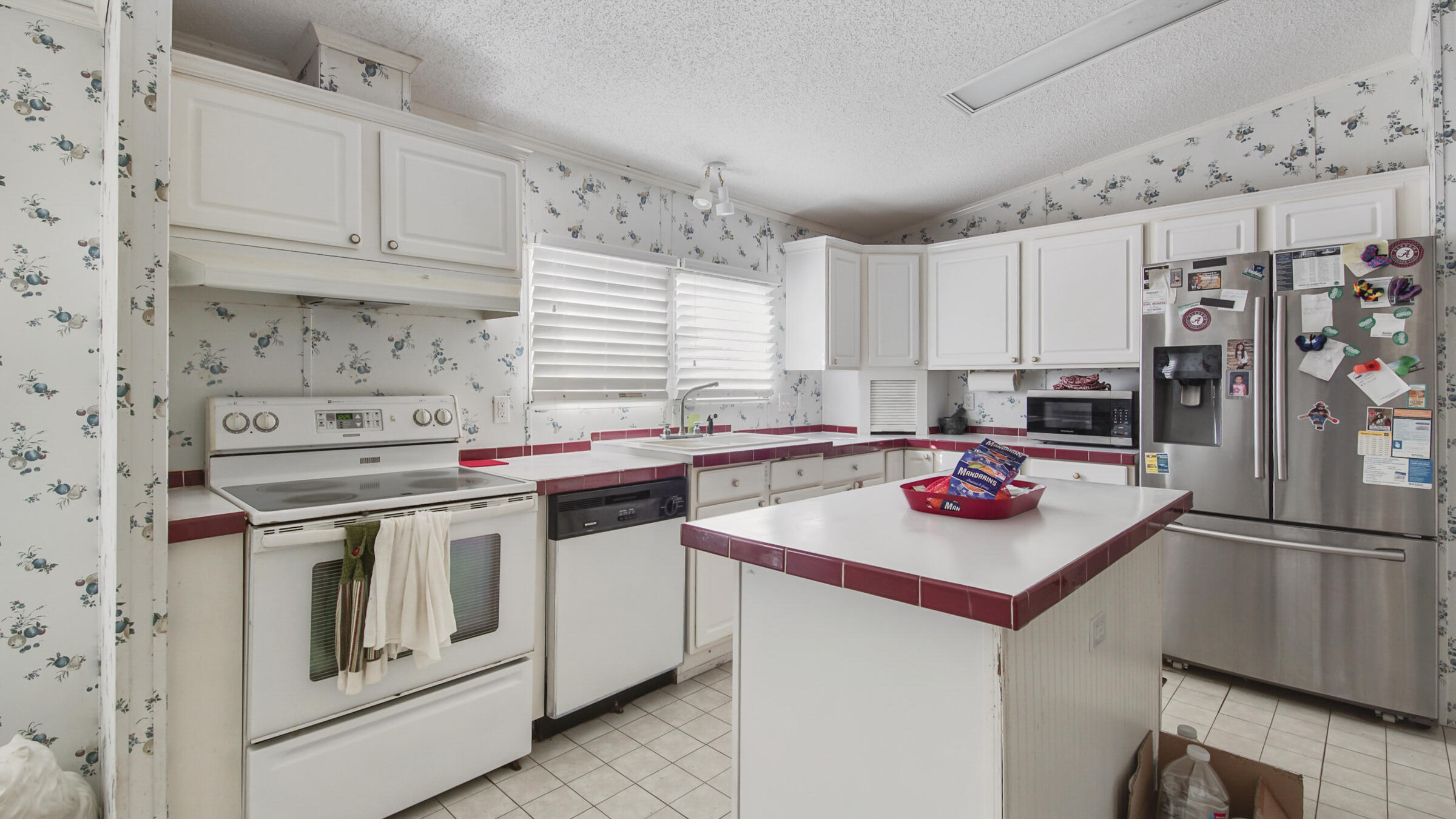 452 Wee Acres Road DeFuniak Springs, FL 32433 - Photo 5 of 23 a kitchen with stainless steel appliances granite countertop a stove and a refrigerator