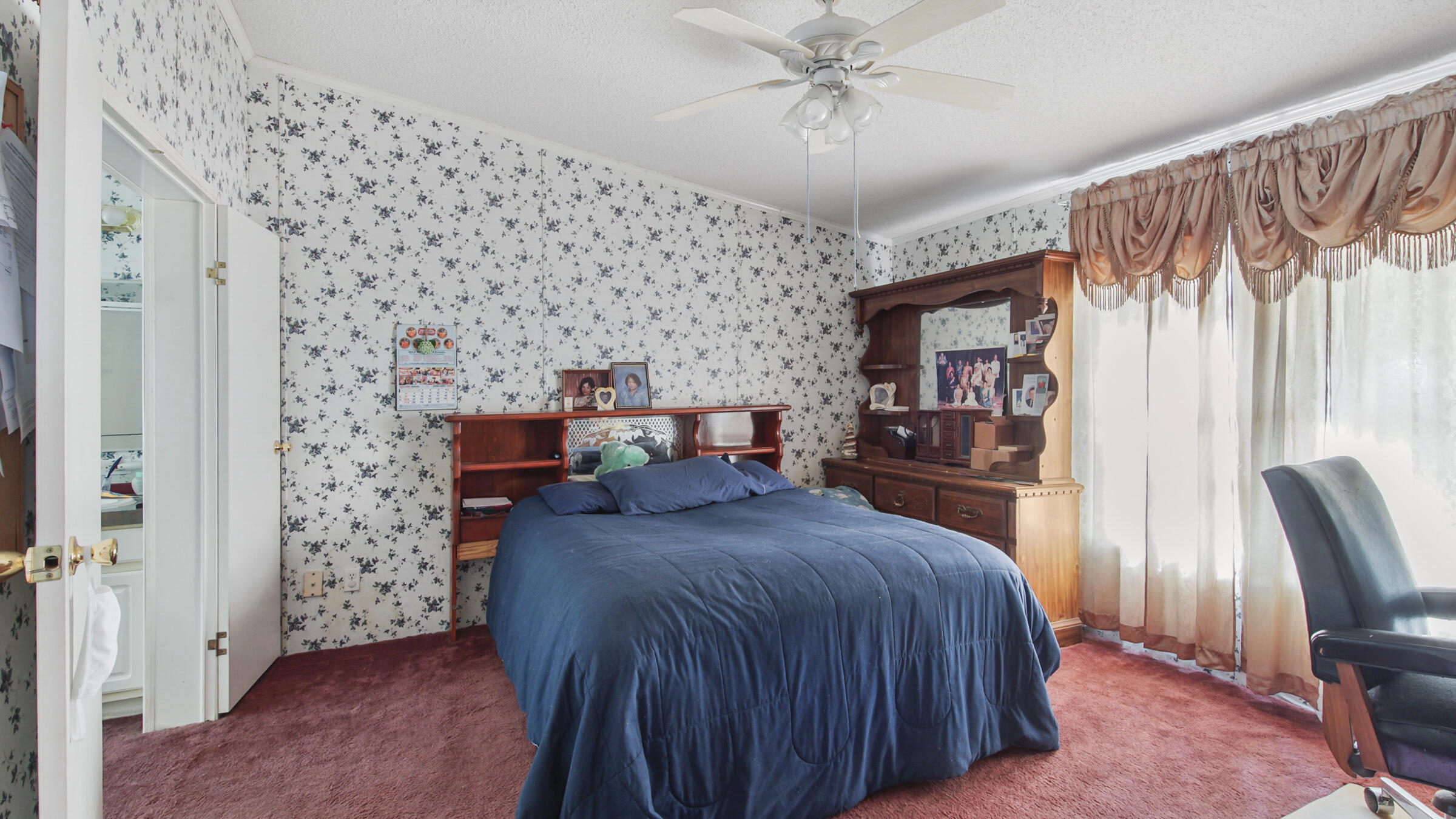 452 Wee Acres Road DeFuniak Springs, FL 32433 - Photo 7 of 23 a bedroom with a bed and a chandelier