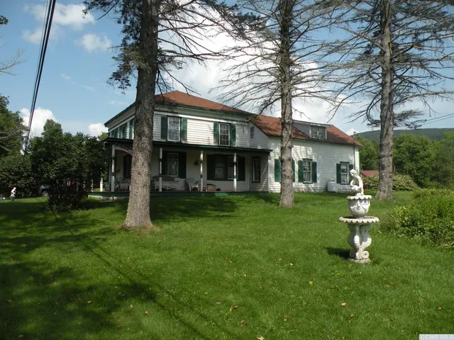 a front view of a house with a yard table and chairs