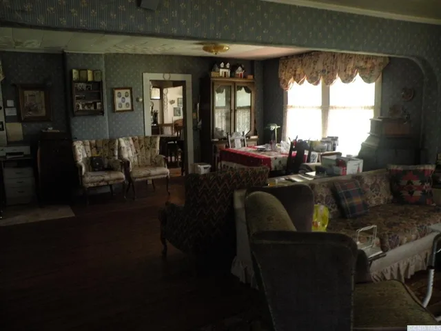 a view of a dining room with furniture and chandelier