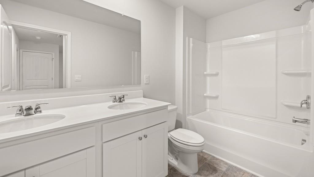 49 Rustin Ridge Dahlonega, GA 30533 - Photo 24 of 27 a bathroom with a sink a toilet and a bathtub