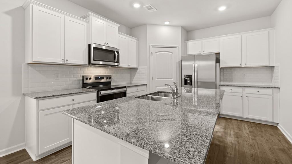 49 Rustin Ridge Dahlonega, GA 30533 - Photo 5 of 27 a kitchen with stainless steel appliances granite countertop a sink a stove and a refrigerator