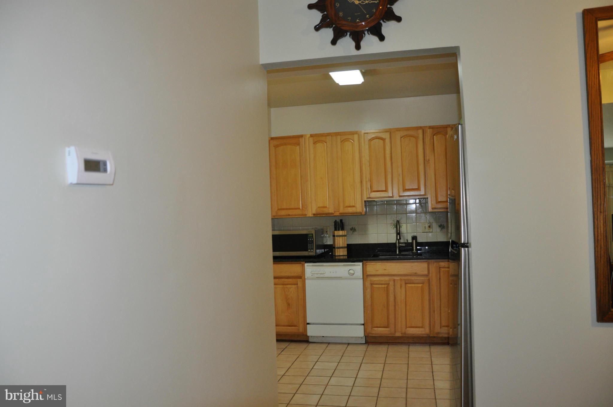 7938 Spring Forest Court, Unit 7938 Springfield, VA 22152 - Photo 11 of 29 a kitchen with a sink a stove a microwave and cabinets