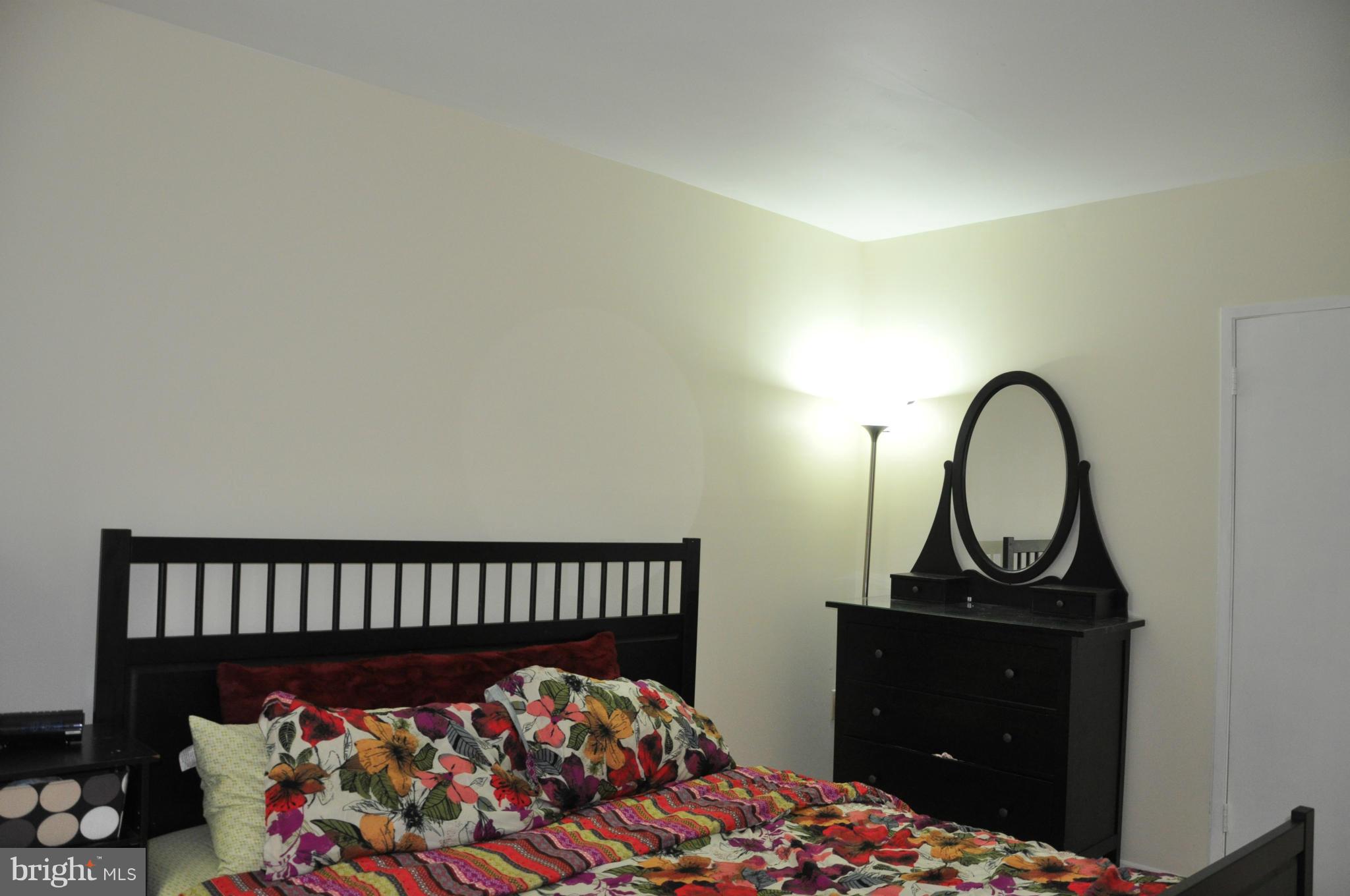 7938 Spring Forest Court, Unit 7938 Springfield, VA 22152 - Photo 19 of 29 a bedroom with a bed and a window