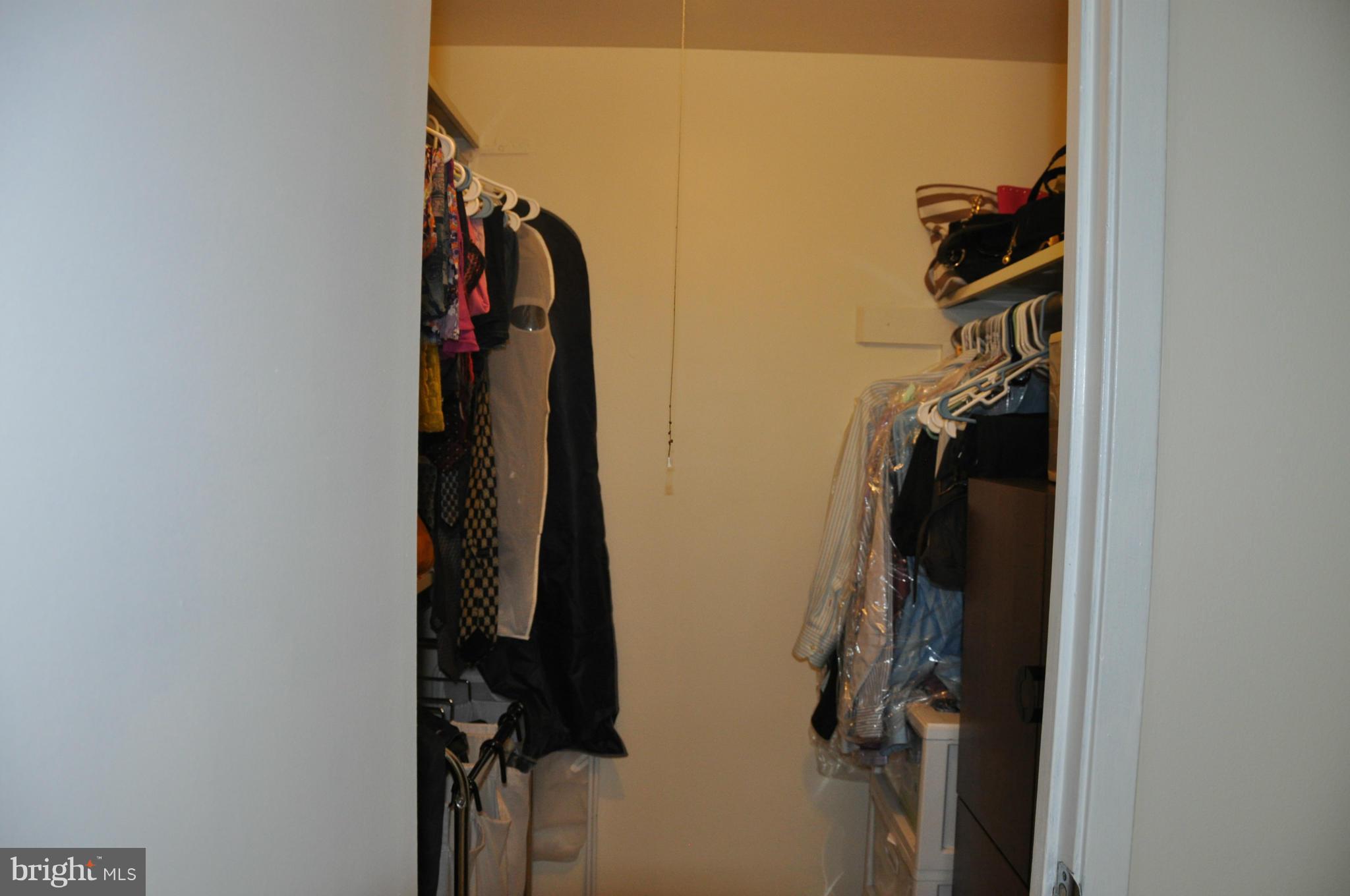 7938 Spring Forest Court, Unit 7938 Springfield, VA 22152 - Photo 20 of 29 a view of walk in closet with clothes and shoes