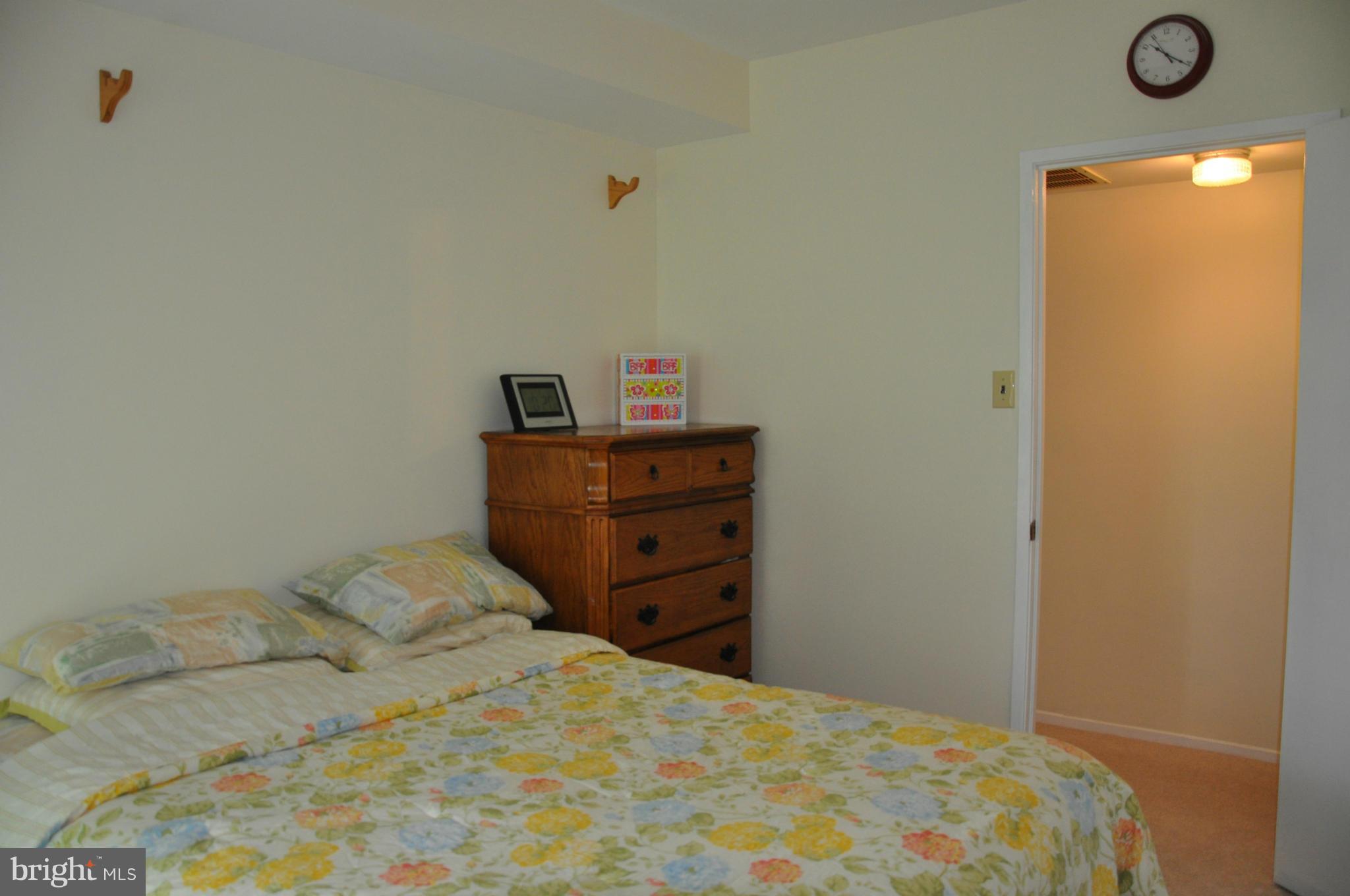 7938 Spring Forest Court, Unit 7938 Springfield, VA 22152 - Photo 23 of 29 a bedroom with a bed and a dresser