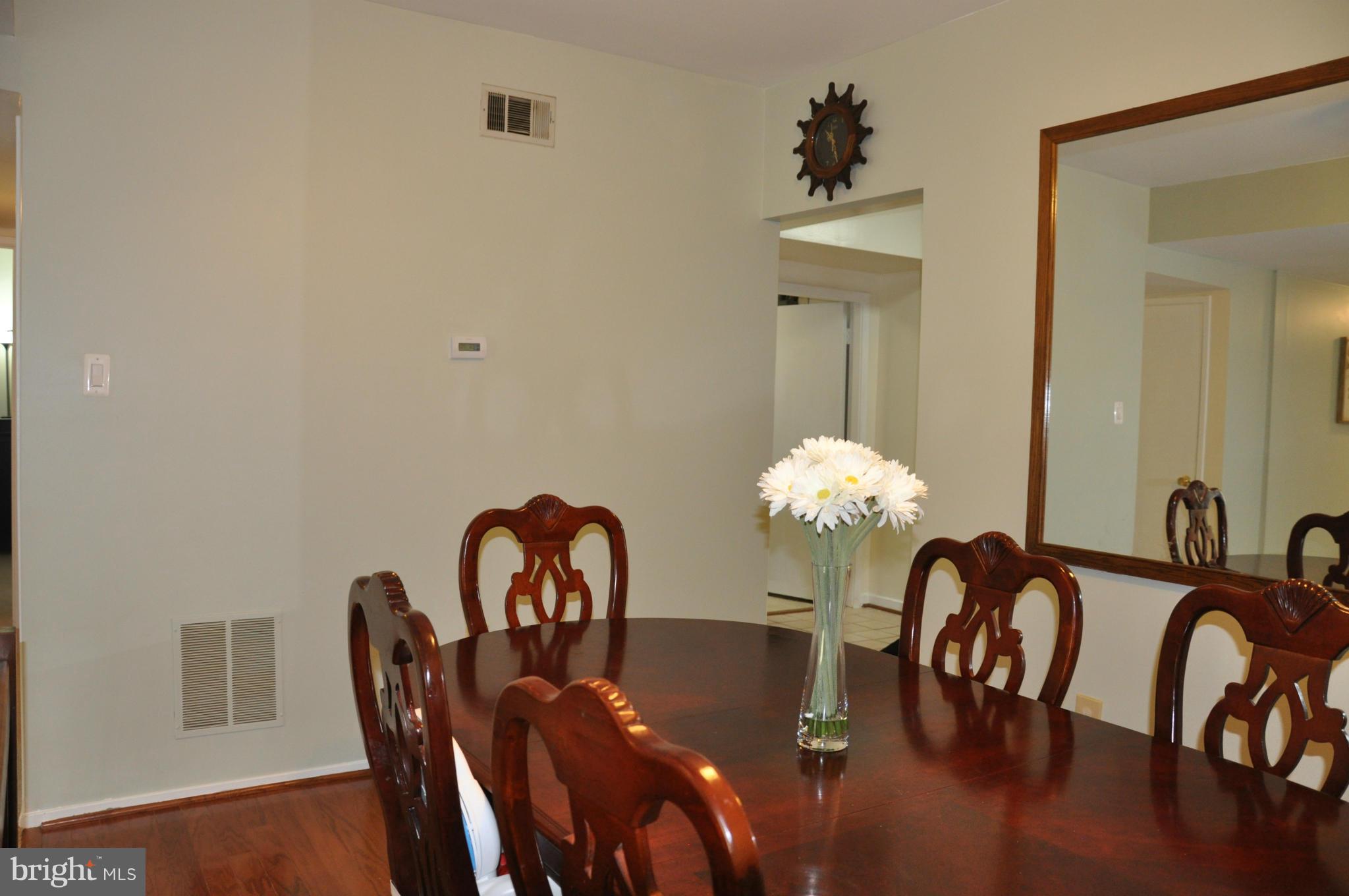 7938 Spring Forest Court, Unit 7938 Springfield, VA 22152 - Photo 9 of 29 a dining room with furniture and chandelier