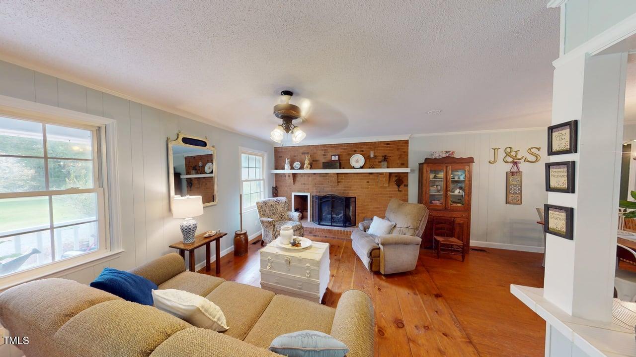 1079 Fate Washington Road Stem, NC 27581 - Photo 8 of 34 a living room with furniture and a fireplace