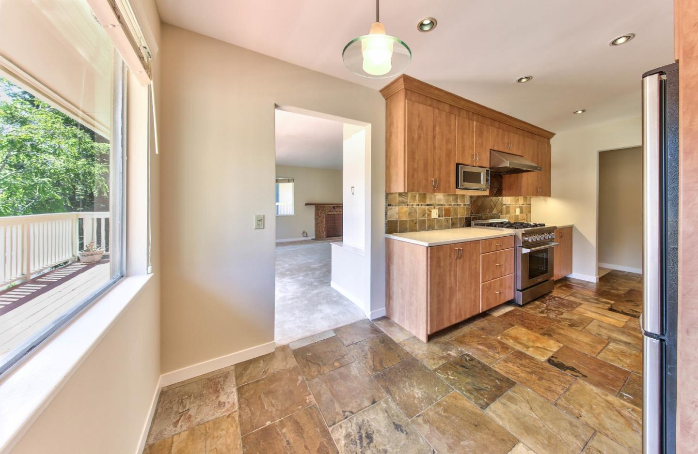 0 Junipero 4 Nw 10th Avenue Carmel, CA 93921 - Photo 7 of 22 a kitchen with stainless steel appliances granite countertop a stove oven and a refrigerator with cabinets