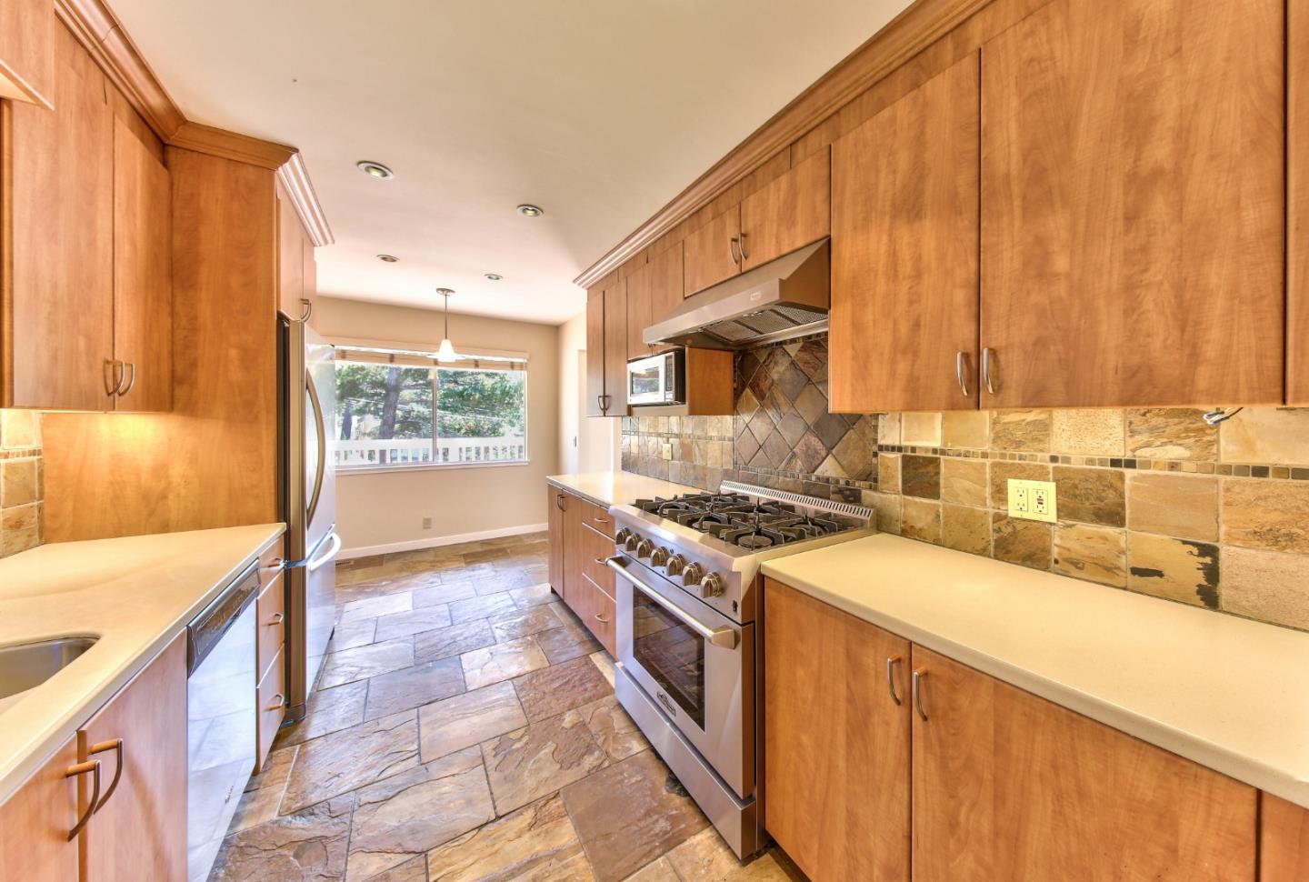 0 Junipero 4 Nw 10th Avenue Carmel, CA 93921 - Photo 9 of 22 a kitchen with stainless steel appliances a stove a sink and a microwave