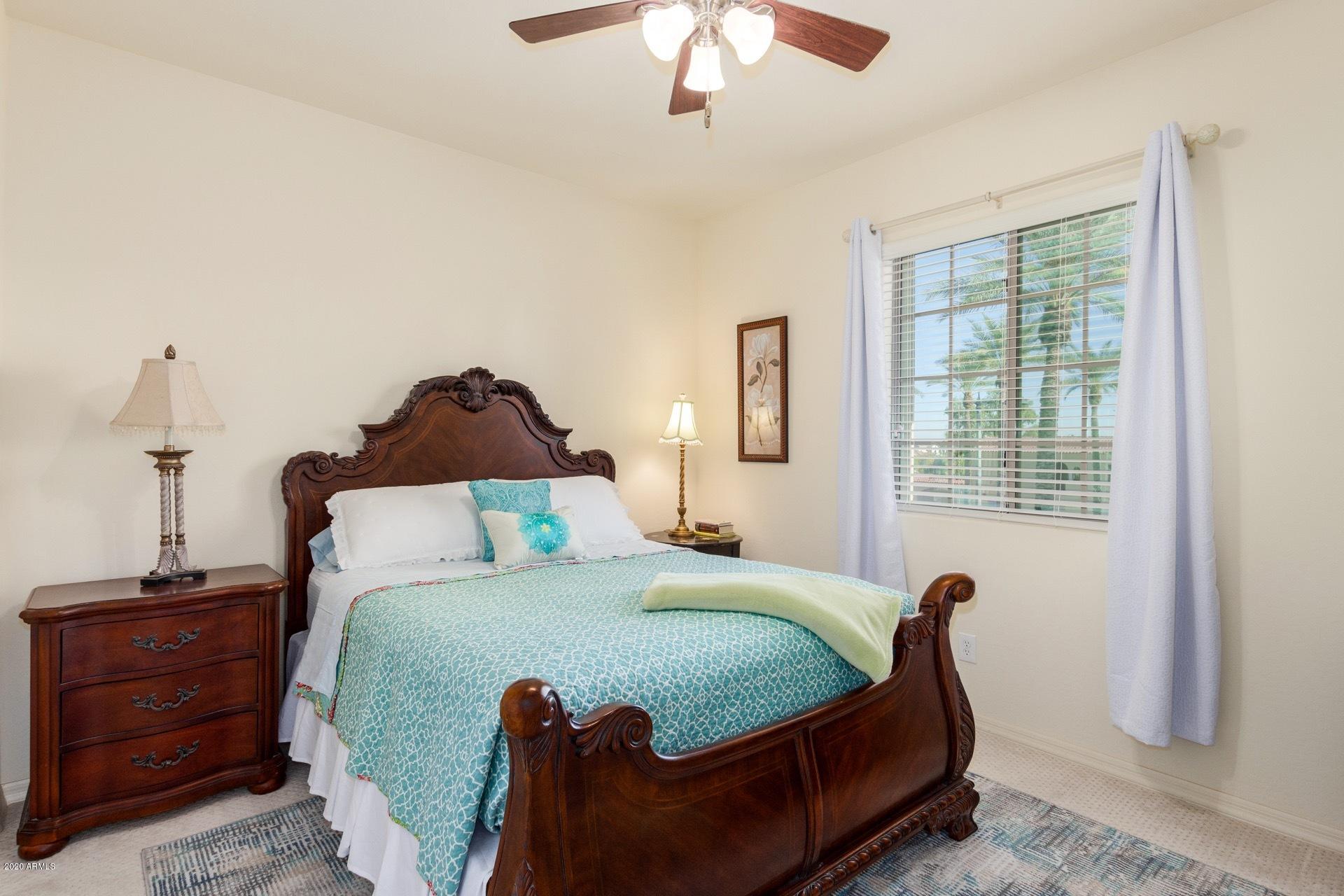 4280 North Verrado Way Buckeye, AZ 85396 - Photo 13 of 41 a bedroom with a bed and window