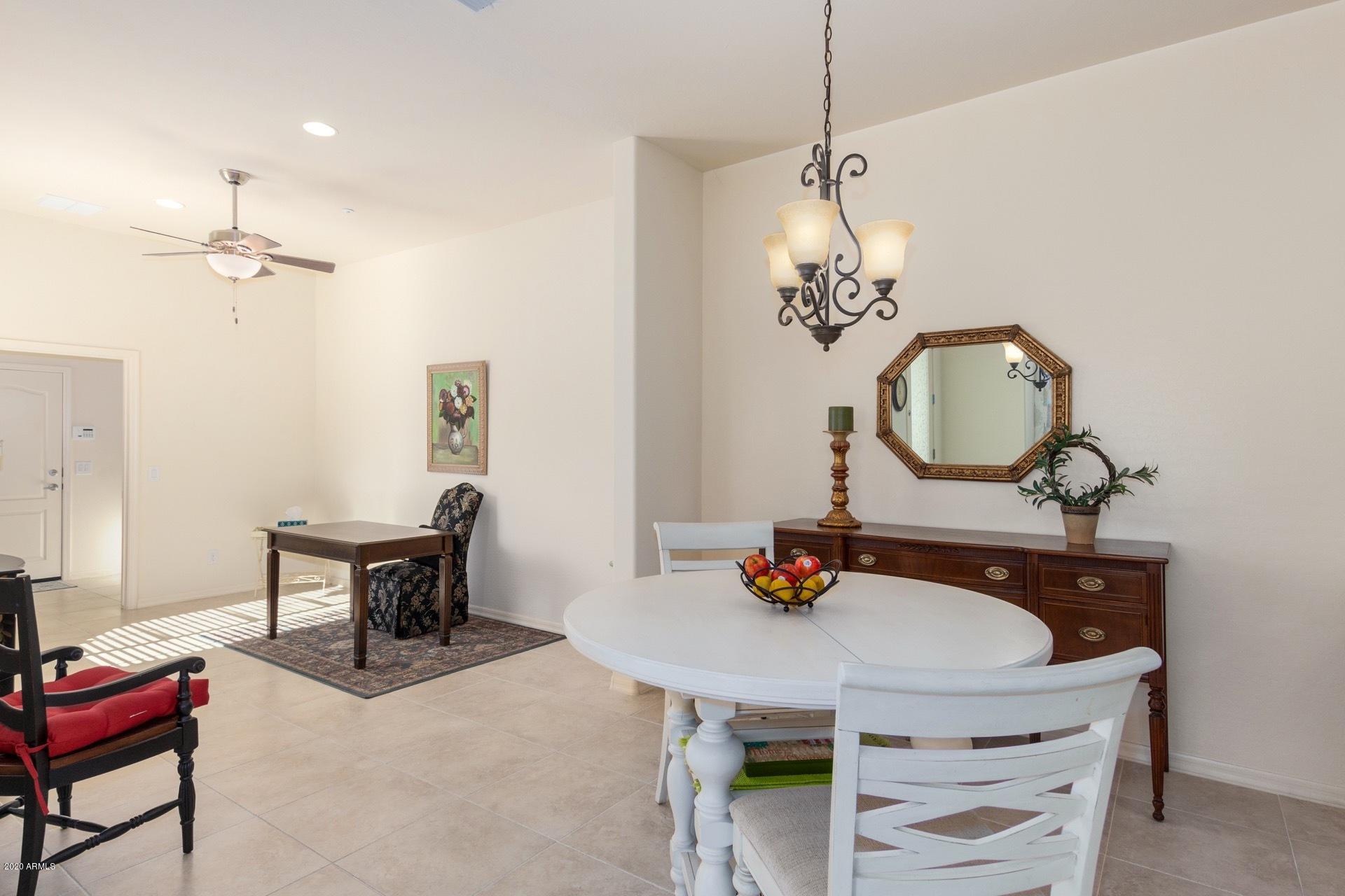 4280 North Verrado Way Buckeye, AZ 85396 - Photo 4 of 41 a dining room with furniture and a mirror