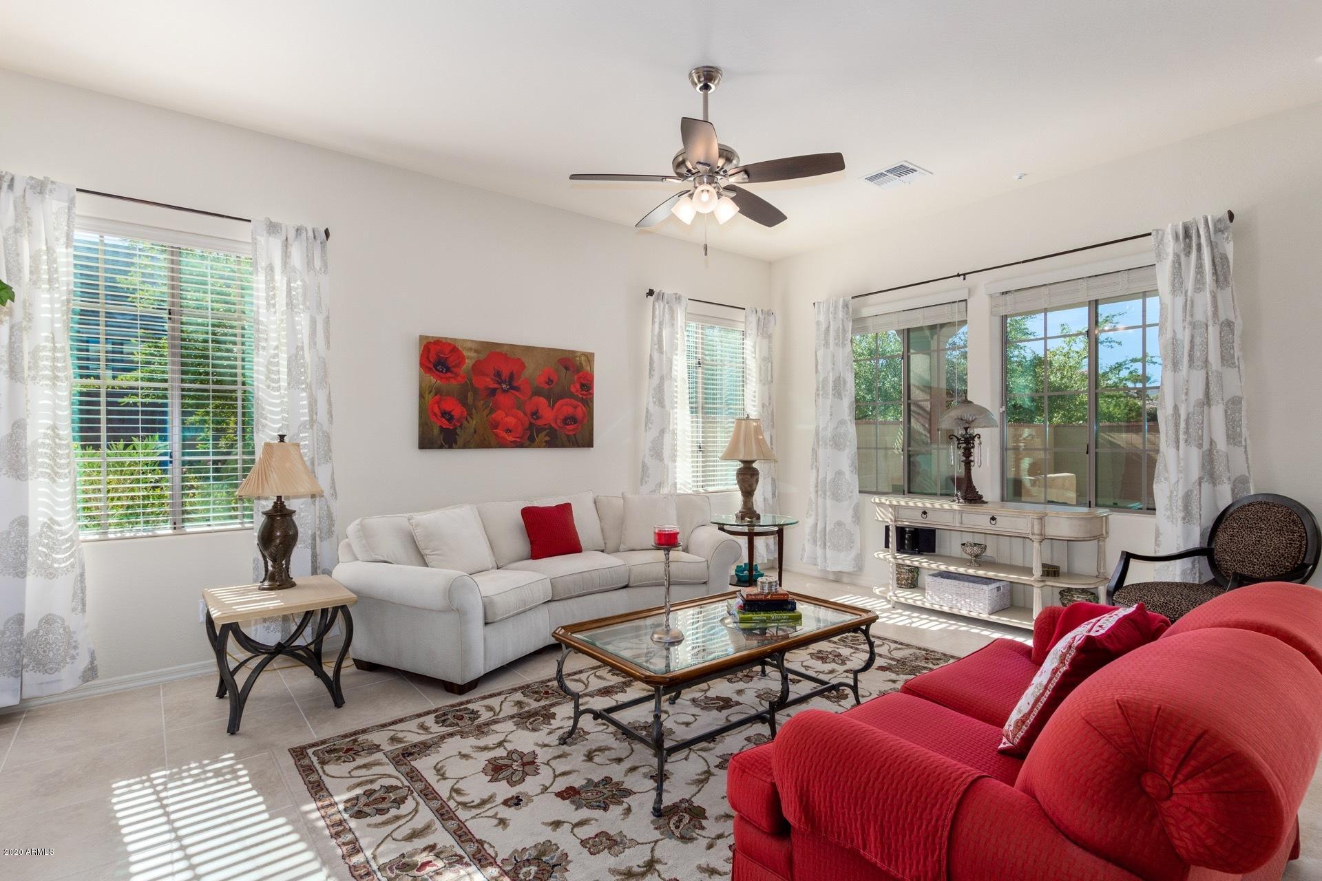 4280 North Verrado Way Buckeye, AZ 85396 - Photo 5 of 41 a living room with furniture and a large window