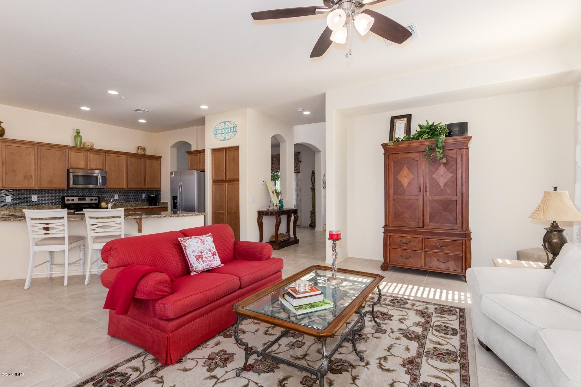 4280 North Verrado Way Buckeye, AZ 85396 - Photo 6 of 41 a living room with furniture and kitchen view
