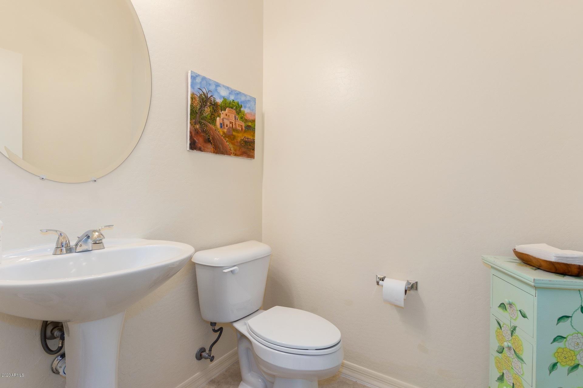 4280 North Verrado Way Buckeye, AZ 85396 - Photo 8 of 41 a bathroom with a toilet a sink and mirror