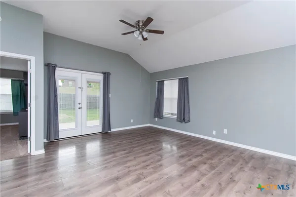 wooden floor in an empty room with a window