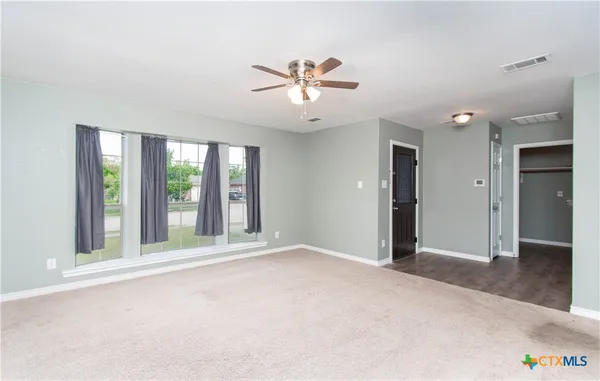 a view of an empty room with a window