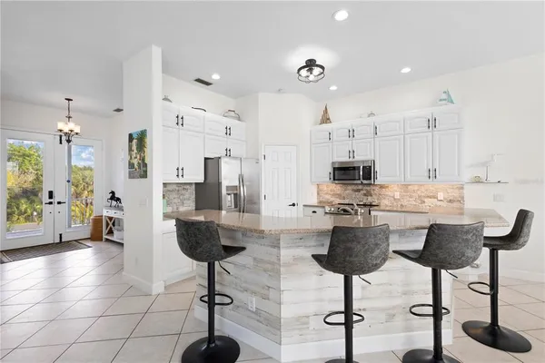 a bathroom with a double vanity sink mirror and next to a window