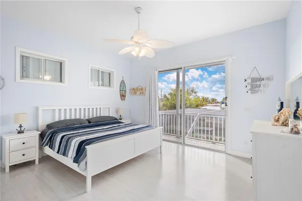 a spacious bedroom with a bed and a lamp