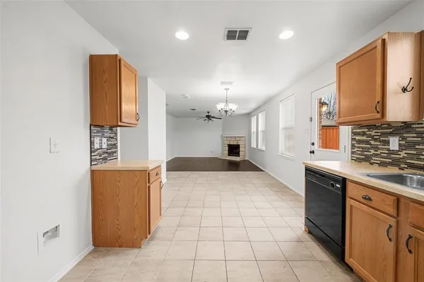 a large kitchen with stainless steel appliances a stove a sink and a refrigerator