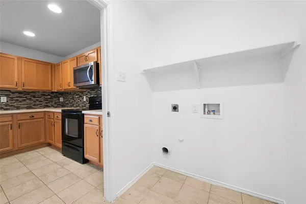 a view of a kitchen with white cabinets