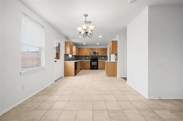 a large white kitchen with cabinets