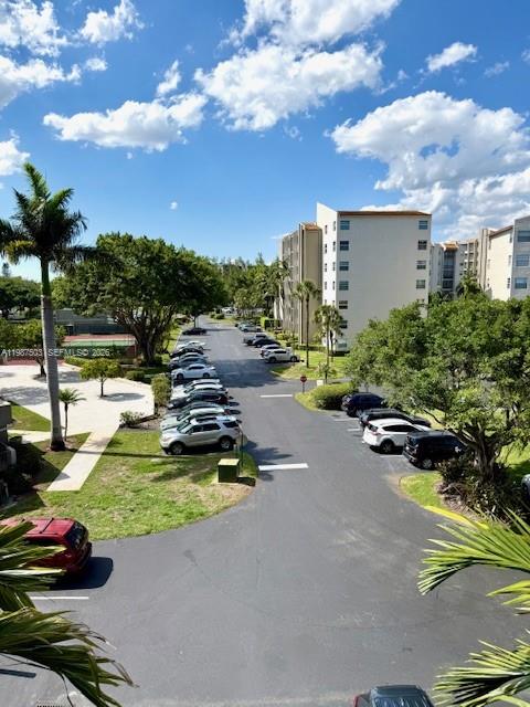 3910 Inverrary Boulevard, Unit 407B Lauderhill, FL 33319 - Photo 19 of 28 a view of a swimming pool and lounge chair