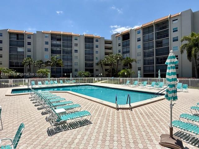 3910 Inverrary Boulevard, Unit 407B Lauderhill, FL 33319 - Photo 24 of 28 a view of a swimming pool with a lounge chairs