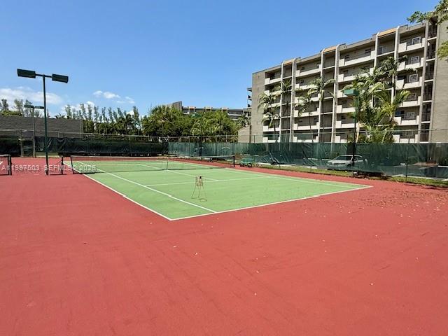 3910 Inverrary Boulevard, Unit 407B Lauderhill, FL 33319 - Photo 26 of 28 a view of a tennis ground with a large trees