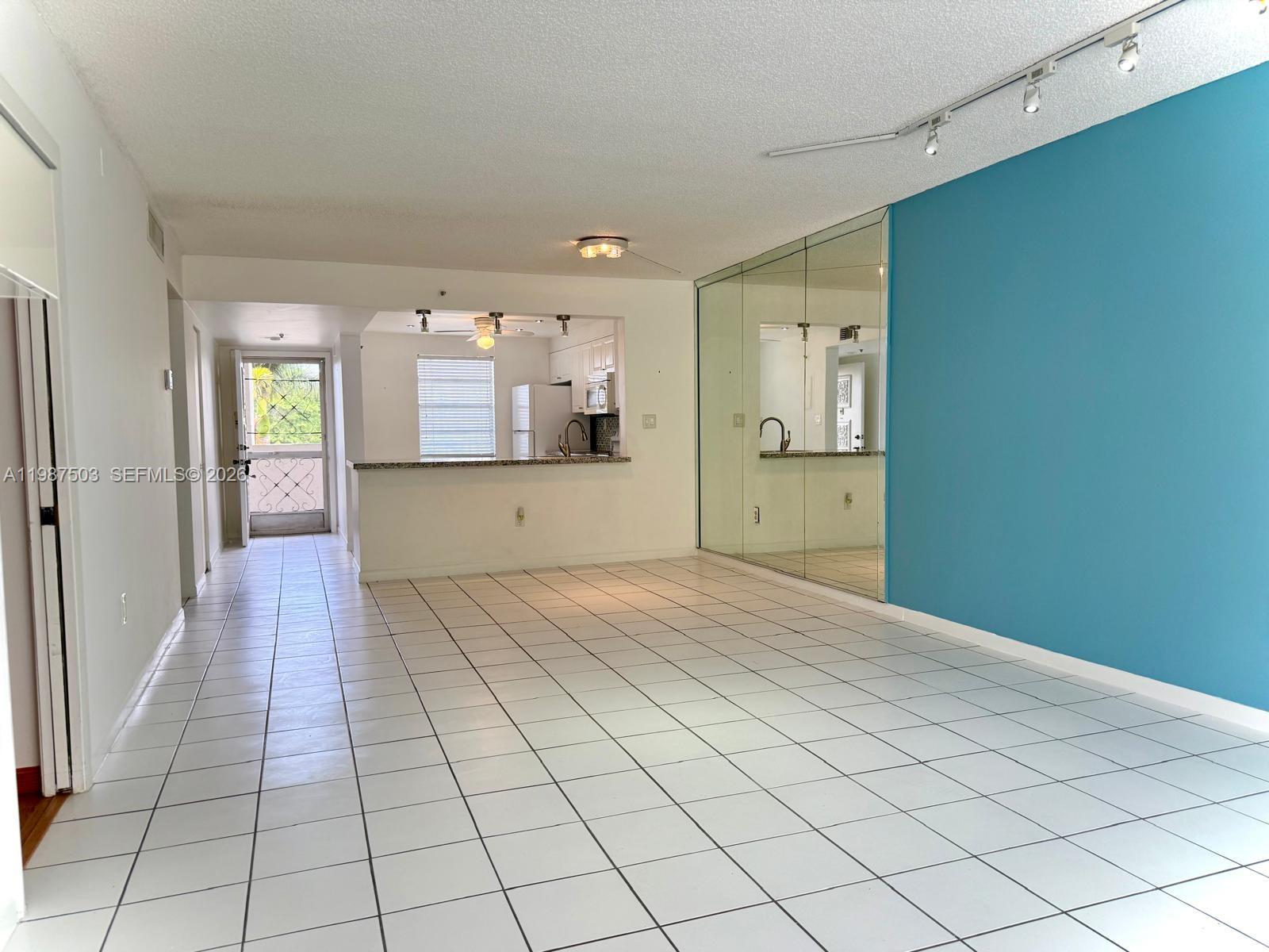 3910 Inverrary Boulevard, Unit 407B Lauderhill, FL 33319 - Photo 4 of 28 a view of a hallway with wooden floor and a living room