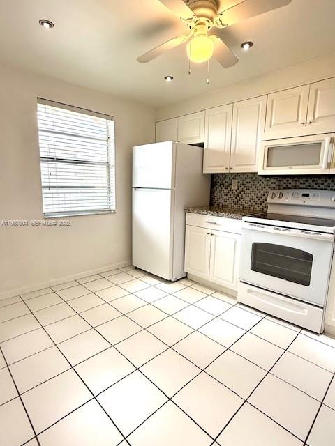 3910 Inverrary Boulevard, Unit 407B Lauderhill, FL 33319 - Photo 7 of 28 a kitchen with a stove a refrigerator and a sink