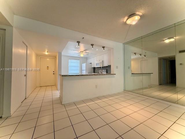 3910 Inverrary Boulevard, Unit 407B Lauderhill, FL 33319 - Photo 8 of 28 a kitchen with stainless steel appliances kitchen island granite countertop a refrigerator and a sink