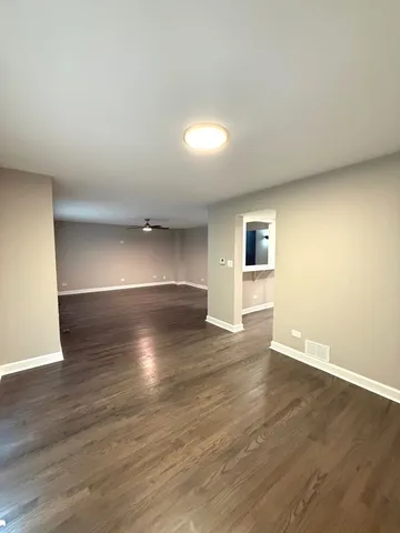 a view of an empty room and wooden floor
