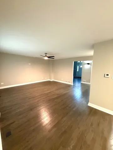 a view of a room with wooden floor