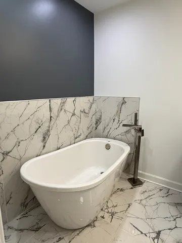 a bathroom with a granite countertop sink mirror and shower